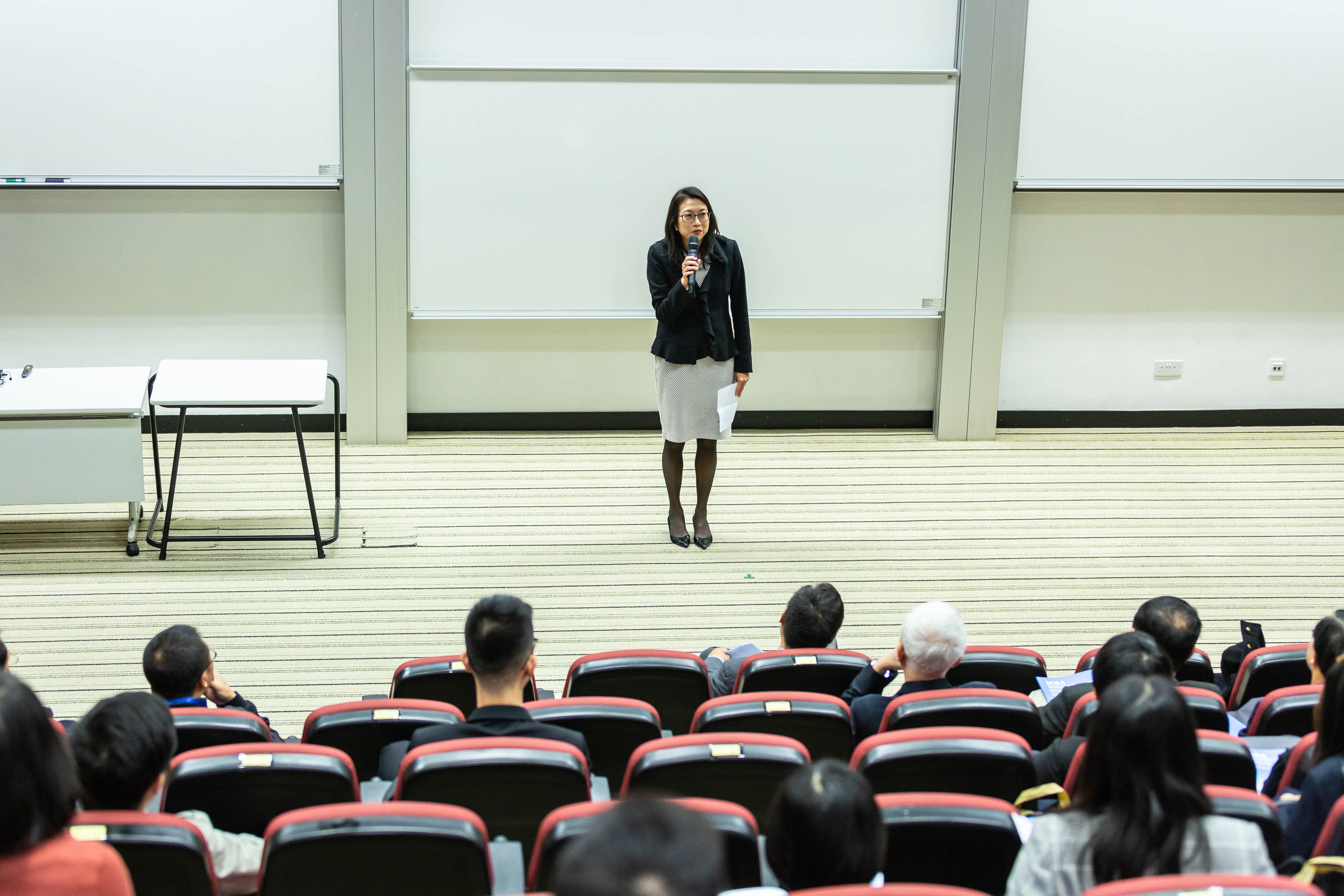 A Female Professor Is Giving A Lecture In Front Of Students English best